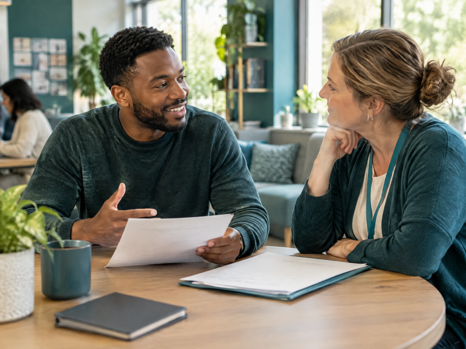 A diverse adult discussing work goals with an employment support adviser